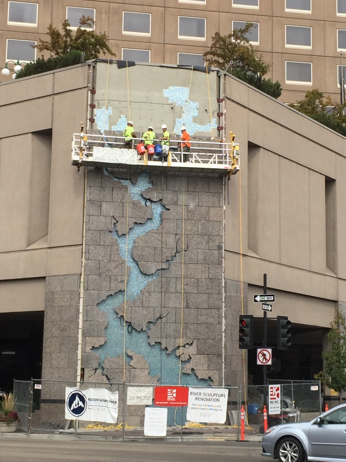 A piece of art depicting the Boise River, in progress of installation on a building downtown!